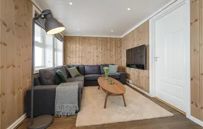 a living room with a couch and a table at Sjusjøen Setergrend 4724 C in Sjusjøen