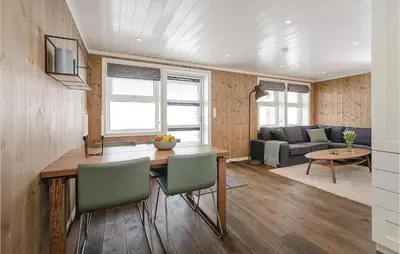 a kitchen and living room with a table and chairs at Sjusjøen Setergrend 4724 C in Sjusjøen