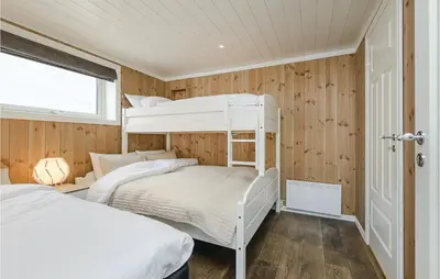 two bunk beds in a room with wooden walls at Sjusjøen Setergrend 4724 C in Sjusjøen