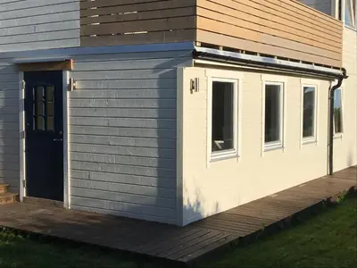 a tiny house with a door and a porch at 1-rom Apartment Sommer - Frøya in Sætra
