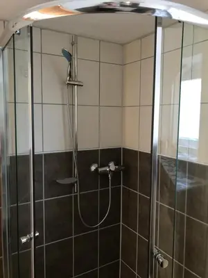 a shower with a glass door in a bathroom at 1-rom Apartment Sommer - Frøya in Sætra