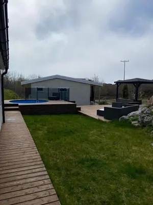 a backyard with a building and a swimming pool at 1-rom Apartment Sommer - Frøya in Sætra