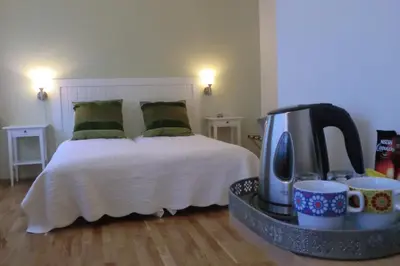a bedroom with a bed with a coffee maker and cups at Lavik Fjord Hotel & Apartments in Lavik