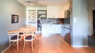 a kitchen with a wooden table and a refrigerator at Geilolia Ferieleiligheter in Geilo