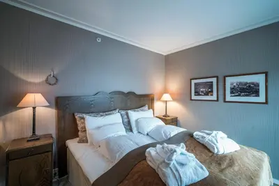 a bedroom with a bed with white sheets and pillows at Angvik Gamle Handelssted - by Classic Norway Hotels in Angvik