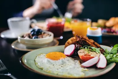 a table with plates of breakfast foods and drinks at Stord Hotel in Stord