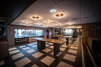 a restaurant with a table in the middle of a room at Stord Hotel in Stord