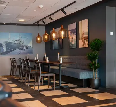 a dining room with a table and chairs at Stord Hotel in Stord