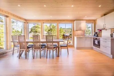 a dining room with a table and chairs in a kitchen at Geilolia Hyttetun in Geilo