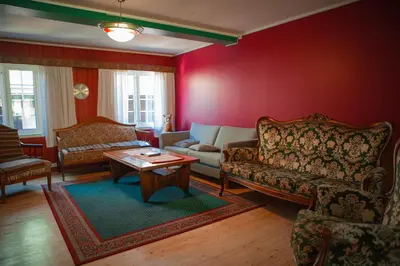 a living room with a couch and a table at Ullensvang Gjesteheim in Lofthus