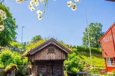 a small wooden house with a thatched roof at Ullensvang Gjesteheim in Lofthus