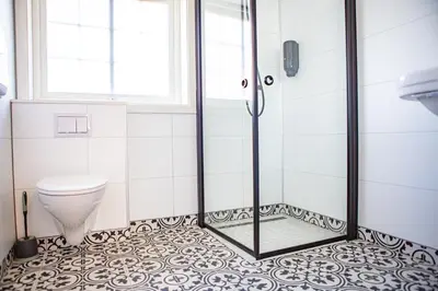 a bathroom with a shower and a toilet at Ullensvang Gjesteheim in Lofthus