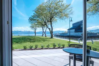a patio with a table and a view of the water at Hardangerfjord Hotel in Øystese