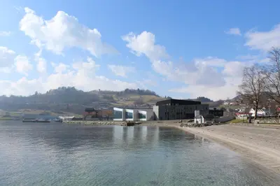 a view of a body of water with a building at Hardangerfjord Hotel in Øystese