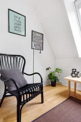 a black chair in a room with a table at LS Apartments in Bergen