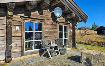 a log cabin with a balloon in the window at Amazing Home In Sjusjøen With Sauna in Sjusjøen