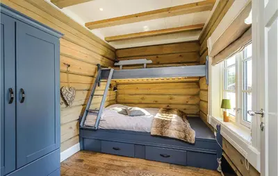 a bedroom with a bunk bed in a log cabin at Amazing Home In Sjusjøen With Sauna in Sjusjøen
