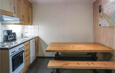 a kitchen with a wooden table and a counter top at Cozy Apartment In Hemsedal With Sauna in Hemsedal