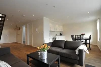 a living room with a couch and a table at Geilo Gaarden in Geilo