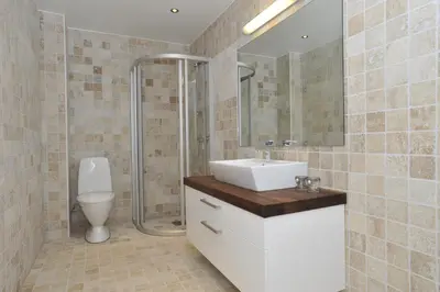 a bathroom with a sink and a toilet and a mirror at Geilo Gaarden in Geilo
