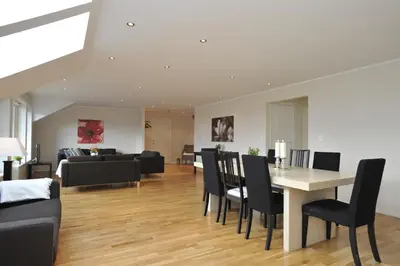 a living room with a table and chairs and a couch at Geilo Gaarden in Geilo