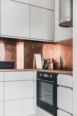 a kitchen with white cabinets and a black oven at Neumannsgate 4 in Bergen
