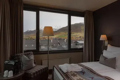a hotel room with a bed and a window at Quality Hotel Skifer in Oppdal