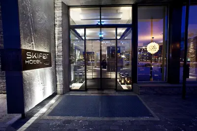 an open glass door of a building with a sign on it at Quality Hotel Skifer in Oppdal