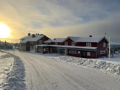 a house in the snow on a dirt road at Lillehammer Fjellstue og Hytteutleie in Nordseter