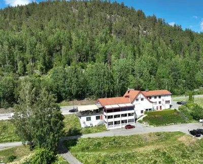 an aerial view of a building in front of a mountain at Kroderen Kro & motel AS in Hamremoen