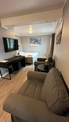 a living room with a couch and a piano at Kroderen Kro & motel AS in Hamremoen