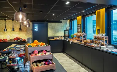a bakery with fruits and pastries on a counter at Thon Hotel Trondheim in Trondheim