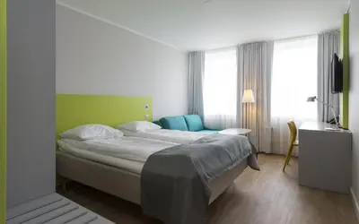 a bedroom with a large bed in a room at Thon Hotel Trondheim in Trondheim