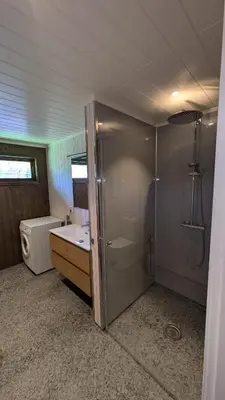 a bathroom with a shower and a toilet and a sink at Weistad in Heidal