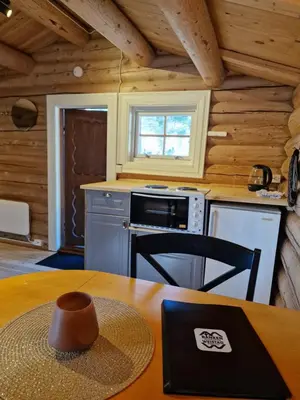 a kitchen with a table with a hat on it at Weistad in Heidal