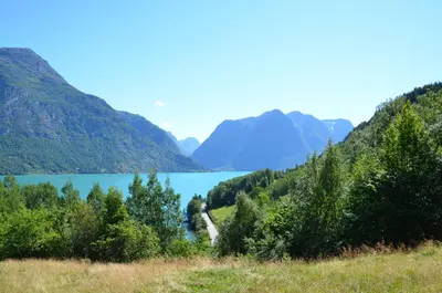 a view of a lake with mountains in the background at Tunold Gård - Gamle huset in Mindresunde