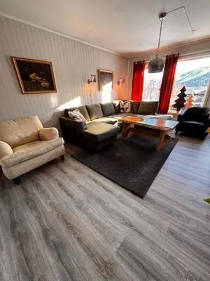 a living room with a couch and a table at Ustedalen Lodge, Appartement 1 in Geilo