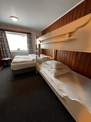 a bedroom with two bunk beds and a window at Ustedalen Lodge, Appartement 1 in Geilo