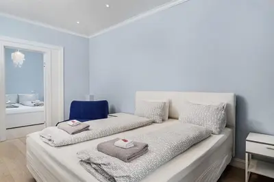 a white room with a bed with towels on it at Apartment with Beautiful View to Bryggen in Bergen