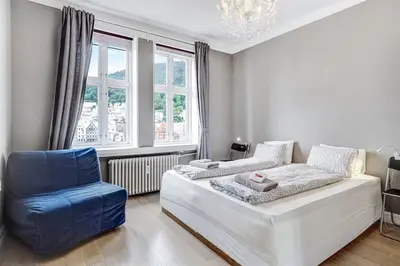 a living room with a couch and a blue chair at Apartment with Beautiful View to Bryggen in Bergen