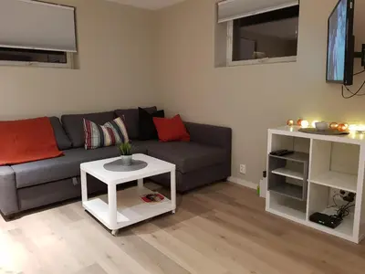a living room with a gray couch and a white table at Apartment at Ranheim in Trondheim