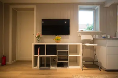 a white cabinet with a tv on top of it at Apartment at Ranheim in Trondheim