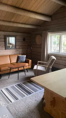 a living room with a couch and a table at Bjerkely, Sjusjøen in Sjusjøen