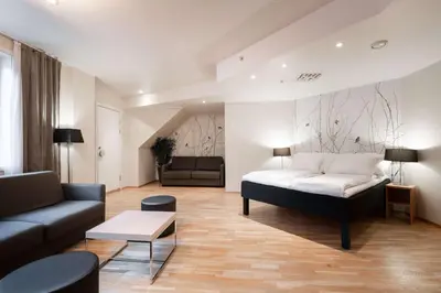 a living room with a bed and a couch at Scandic Byparken in Bergen