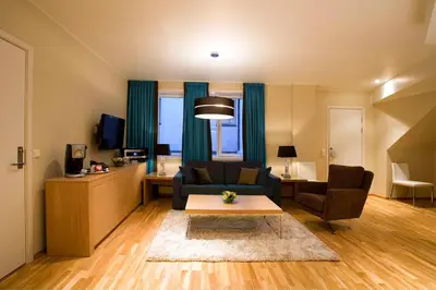 a living room with a couch and a table at Scandic Byparken in Bergen