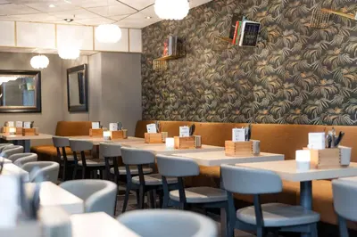 a row of tables and chairs in a restaurant at Scandic Byparken in Bergen