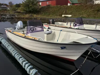 two boats are docked at a dock in the water at Leite Gård near Atlantic Road in Hustadvika in Lyngstad