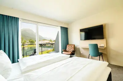 a hotel room with a large bed and a window at Stryn Hotel in Stryn