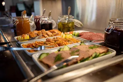 a buffet with several trays of food on a table at Stryn Hotel in Stryn