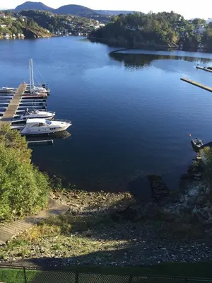 a couple of boats are docked in a lake at Knudsen Apartment in Bergen